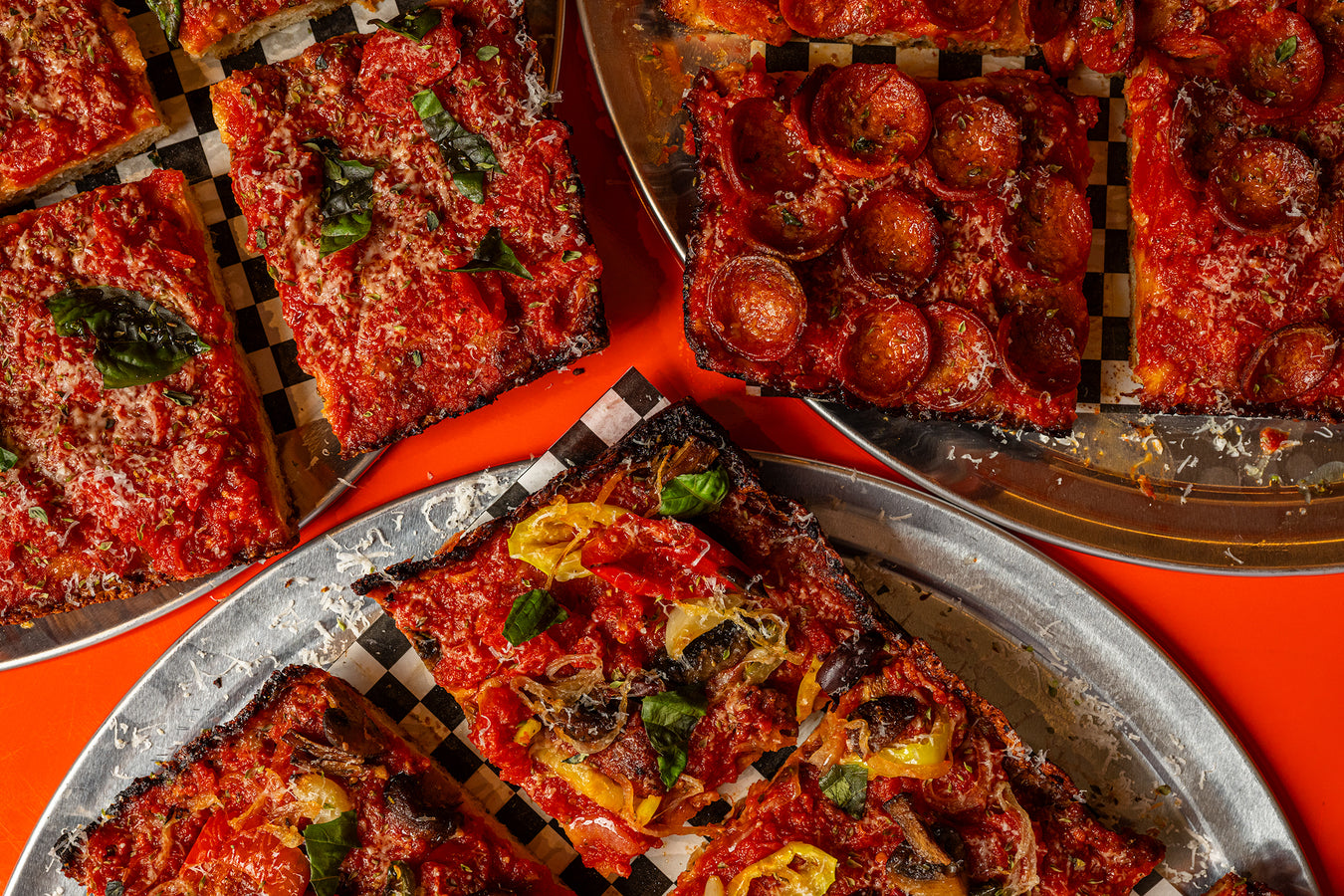 Three Sicilian pies on trays - margherita, pepperoni and vegetable