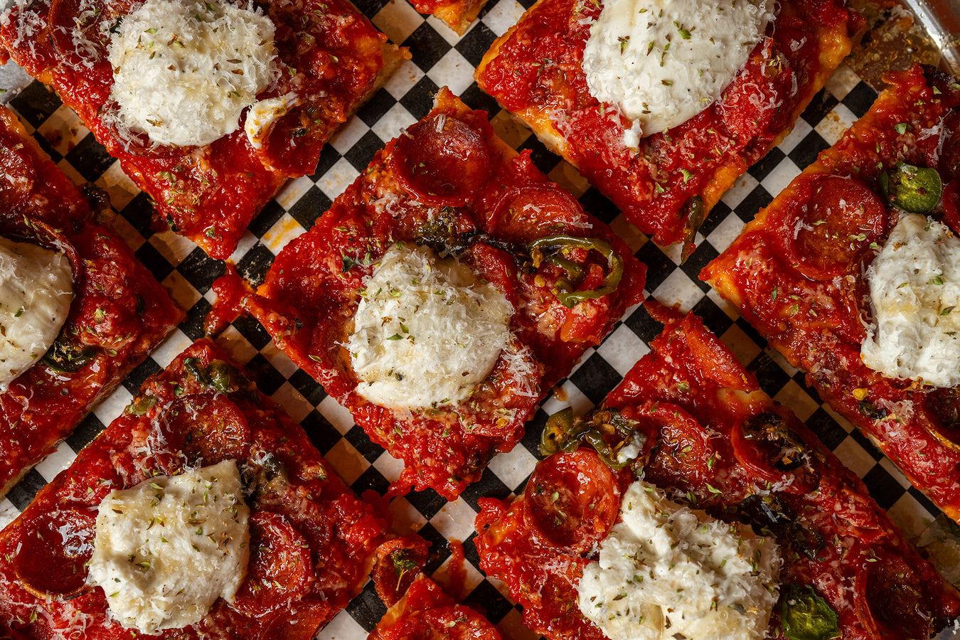 Close up of Sicilian pizza squares with fresh mozzarella